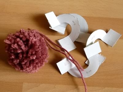 Cut out your card in the shape of my pom pom makers and make in the same way - not quite so easy as they won't snap together - but if you are careful winding the wool this should hold them in place for you to cut.